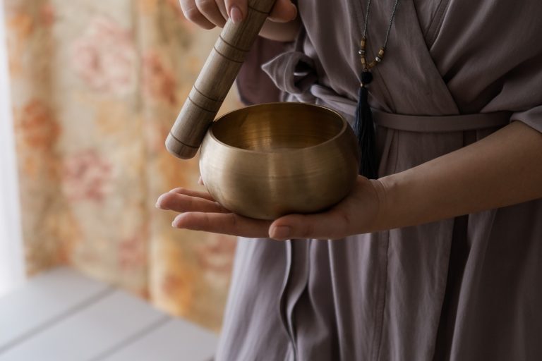 woman-holding-in-hands-bronze-tibetan-singing-bowl-with-wooden-stick-sound-healing-sound-bath-therapy_t20_eVR8w7